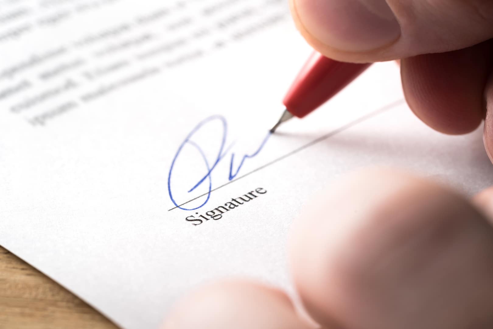 A client signs estate planning documents.